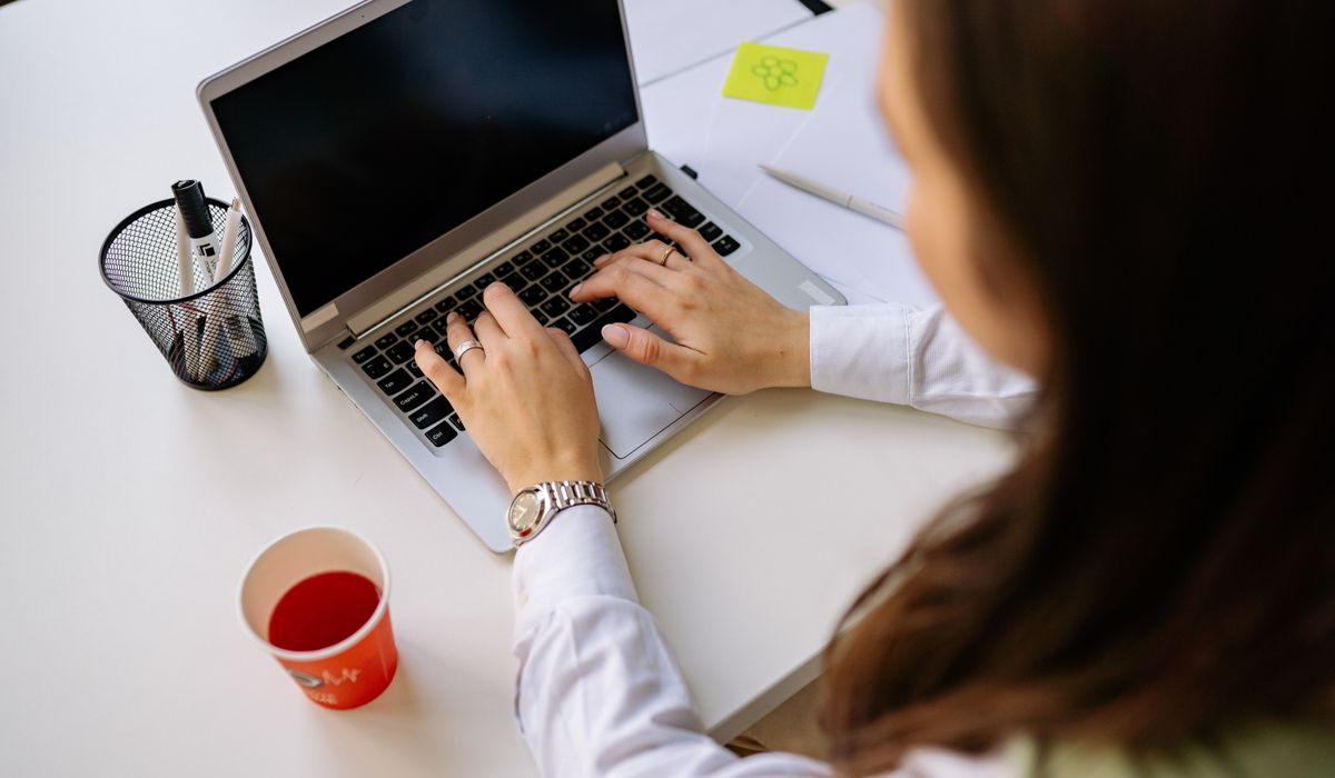 Person filling out an online form on a laptop